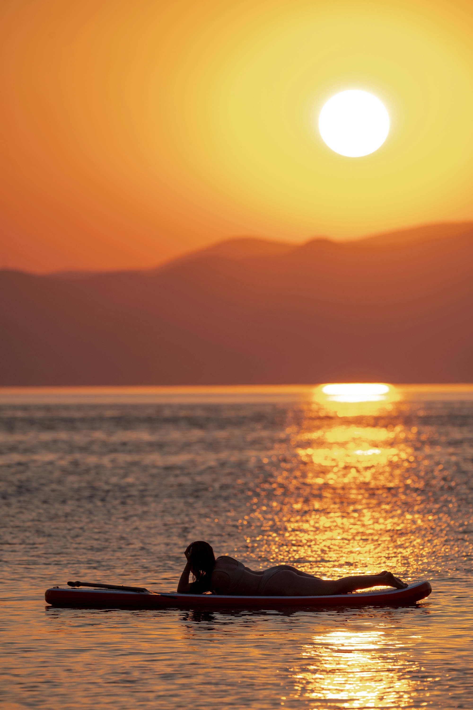 paddleboarding sunset open ocean